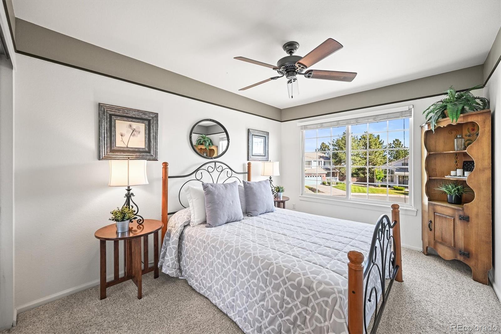 6242 Shea Place Highlands Ranch, CO 80130 - Photo 28 of 45 a bedroom with a bed and a chandelier