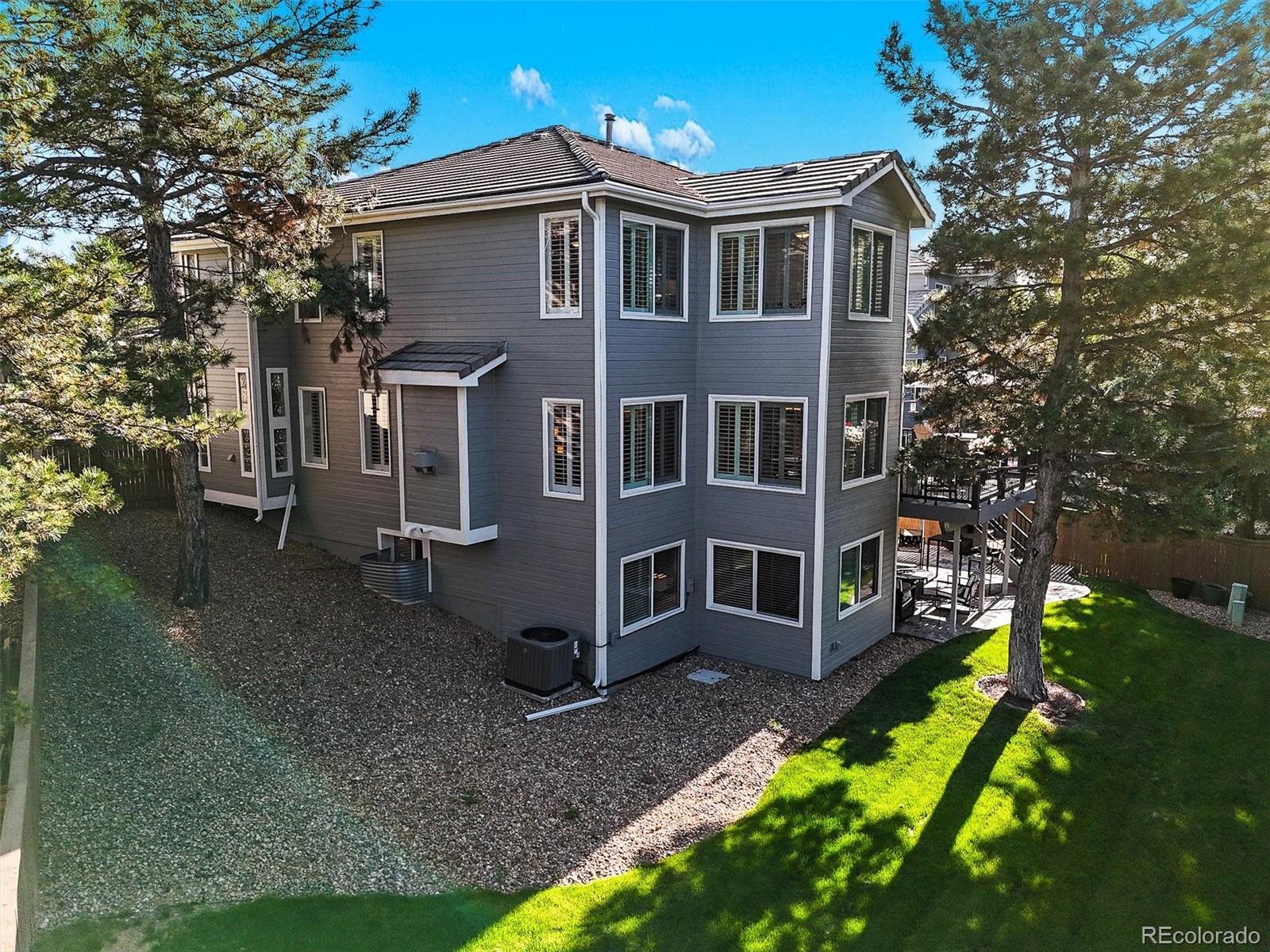 6242 Shea Place Highlands Ranch, CO 80130 - Photo 29 of 45 a front view of a house with yard and green space