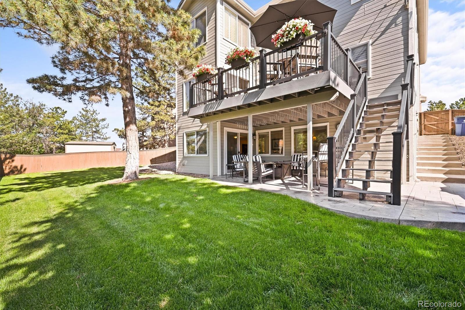 6242 Shea Place Highlands Ranch, CO 80130 - Photo 30 of 45 a view of a house with a yard and sitting area