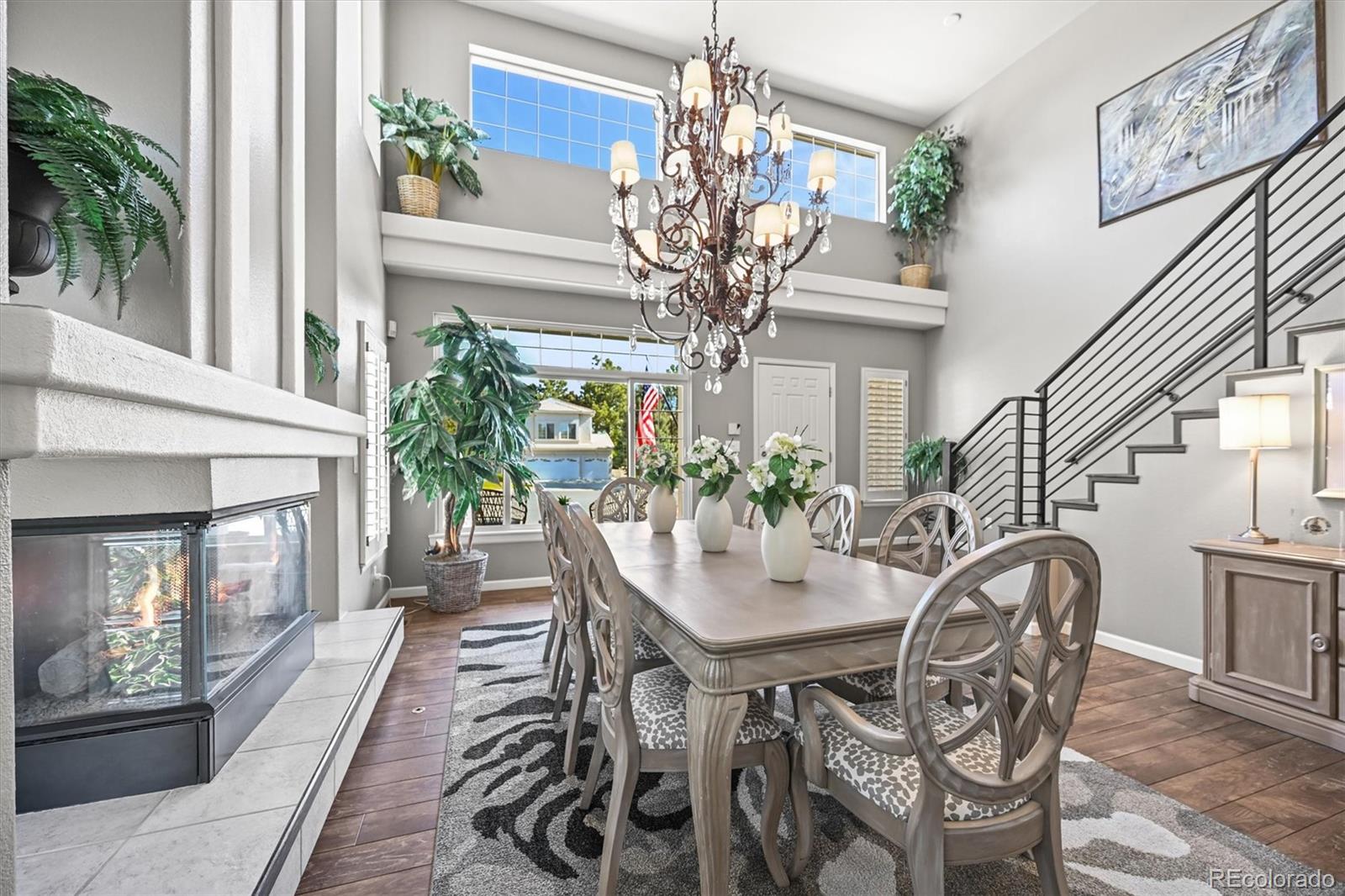 6242 Shea Place Highlands Ranch, CO 80130 - Photo 3 of 45 a view of a dining room with furniture and a chandelier