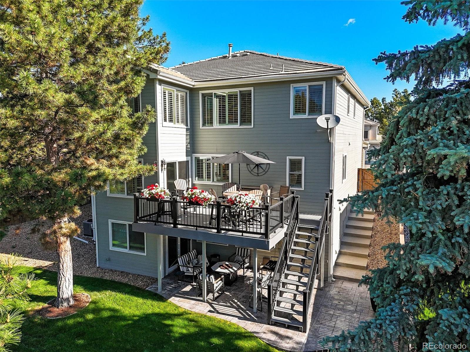 6242 Shea Place Highlands Ranch, CO 80130 - Photo 31 of 45 a front view of house with yard and outdoor seating