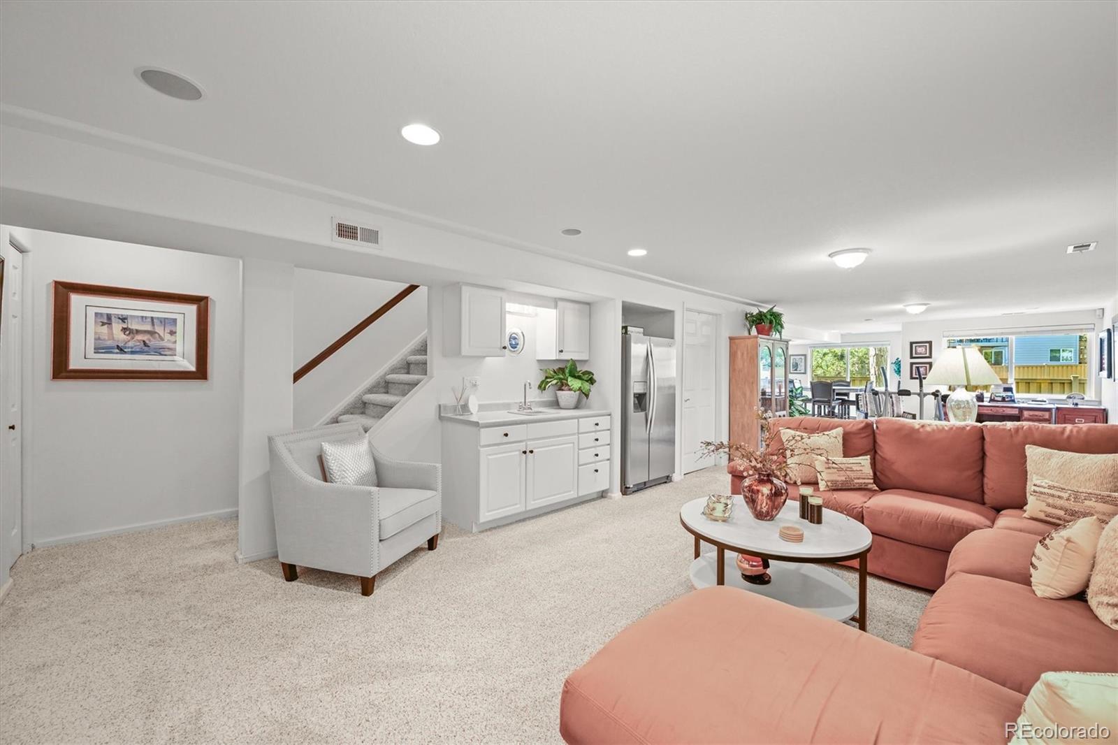 6242 Shea Place Highlands Ranch, CO 80130 - Photo 34 of 45 a living room with furniture and a view of kitchen