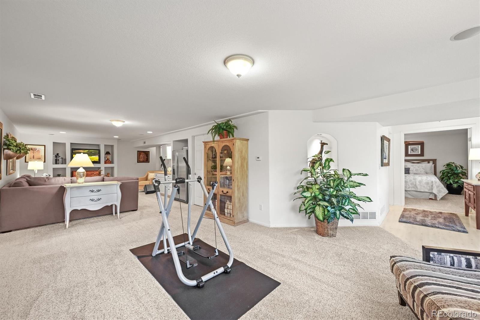 6242 Shea Place Highlands Ranch, CO 80130 - Photo 39 of 45 a view of a livingroom with furniture and a gym