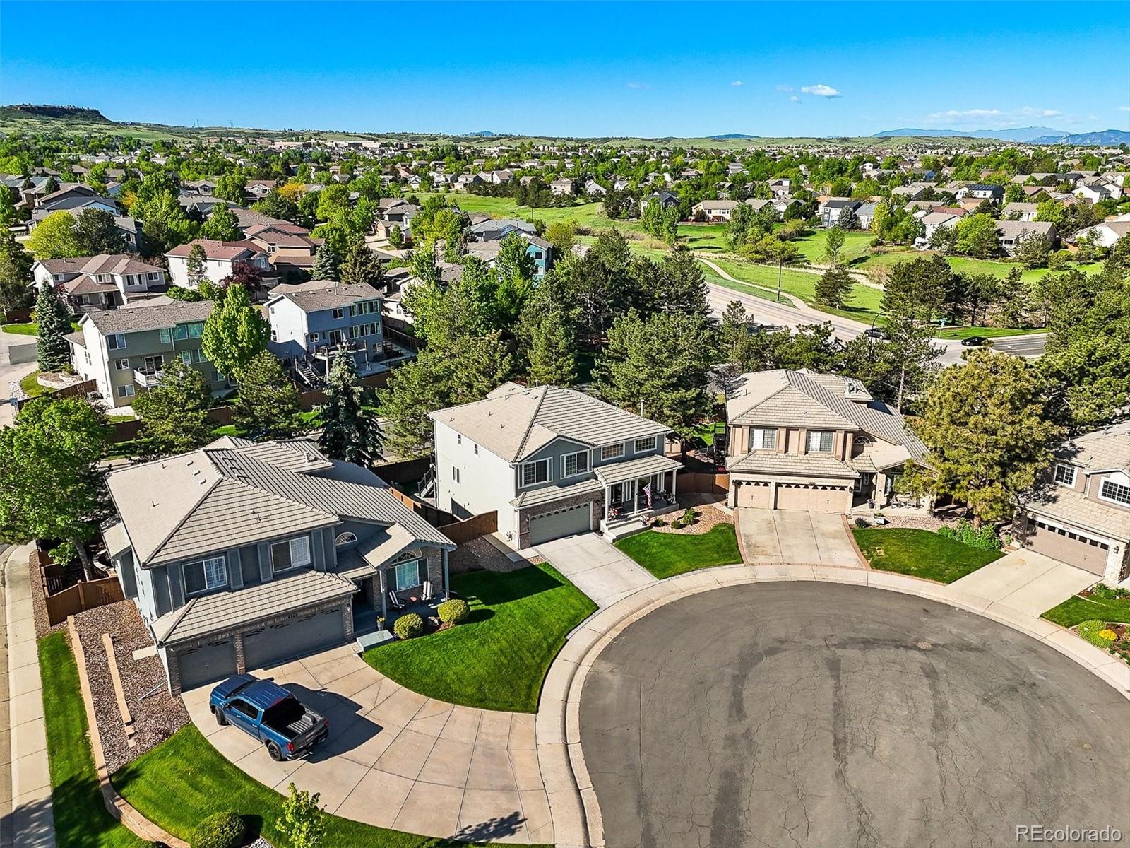 6242 Shea Place Highlands Ranch, CO 80130 - Photo 42 of 45 an aerial view of a house with a garden and lake view