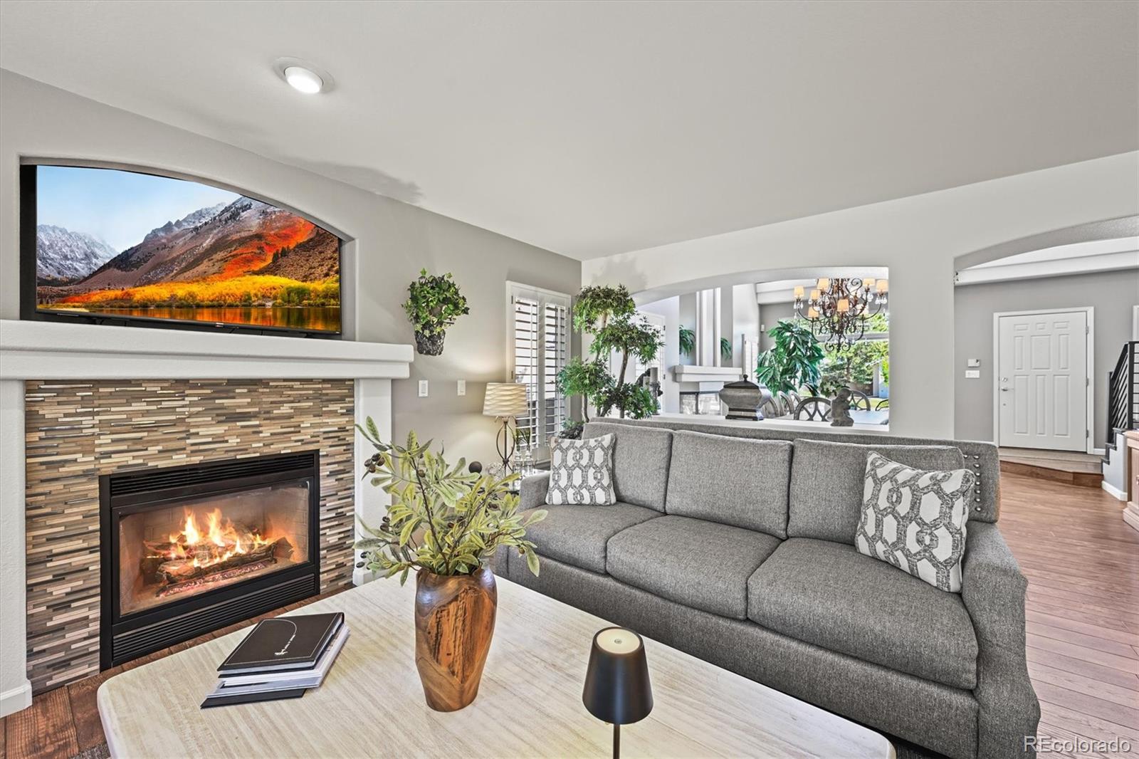 6242 Shea Place Highlands Ranch, CO 80130 - Photo 5 of 45 a living room with furniture and a fireplace
