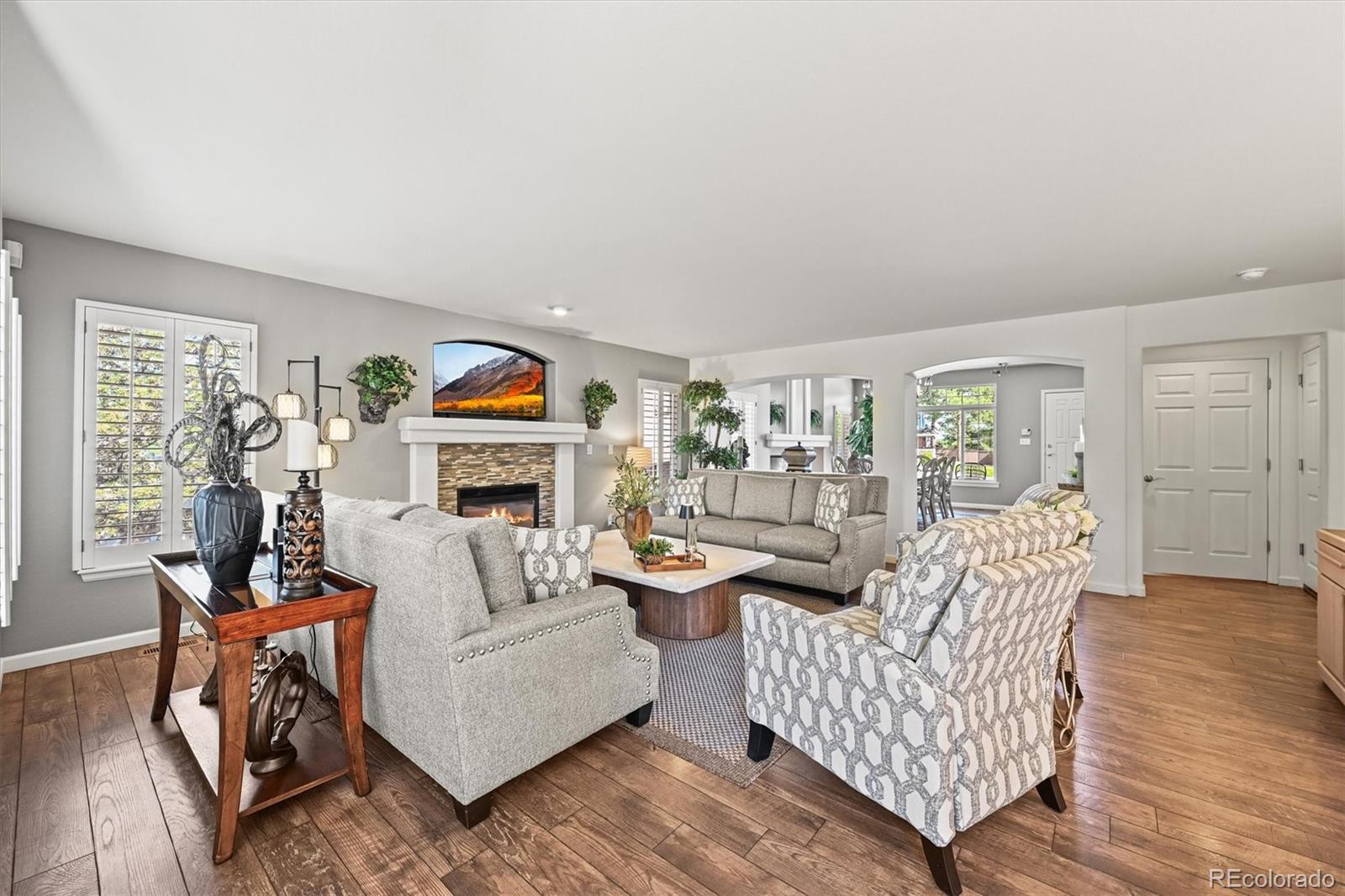 6242 Shea Place Highlands Ranch, CO 80130 - Photo 6 of 45 a living room with furniture and wooden floor