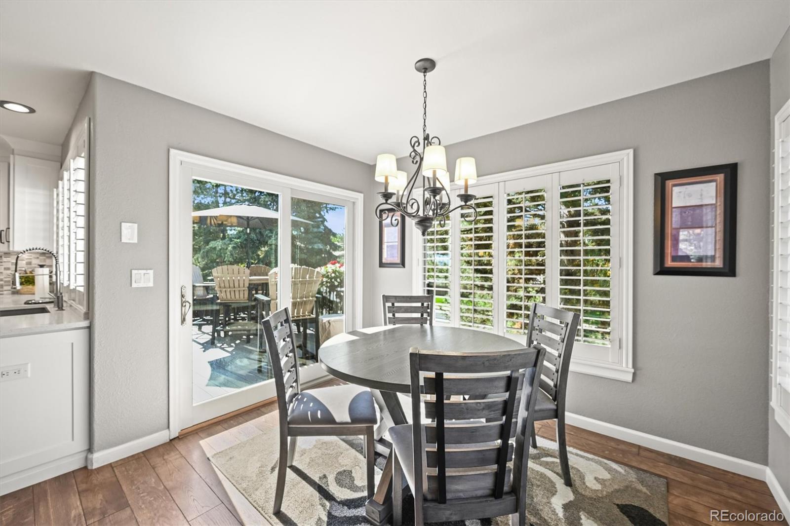6242 Shea Place Highlands Ranch, CO 80130 - Photo 7 of 45 a view of a dining room with furniture window and wooden floor