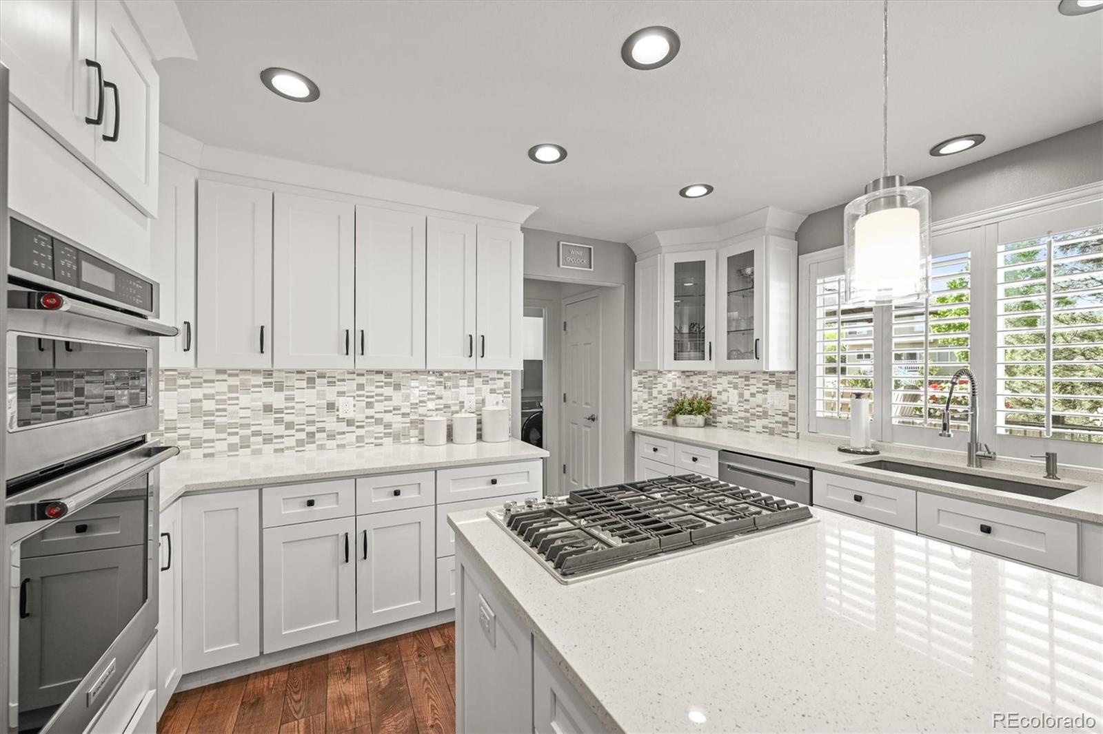 6242 Shea Place Highlands Ranch, CO 80130 - Photo 9 of 45 a kitchen with granite countertop a sink stove and cabinets