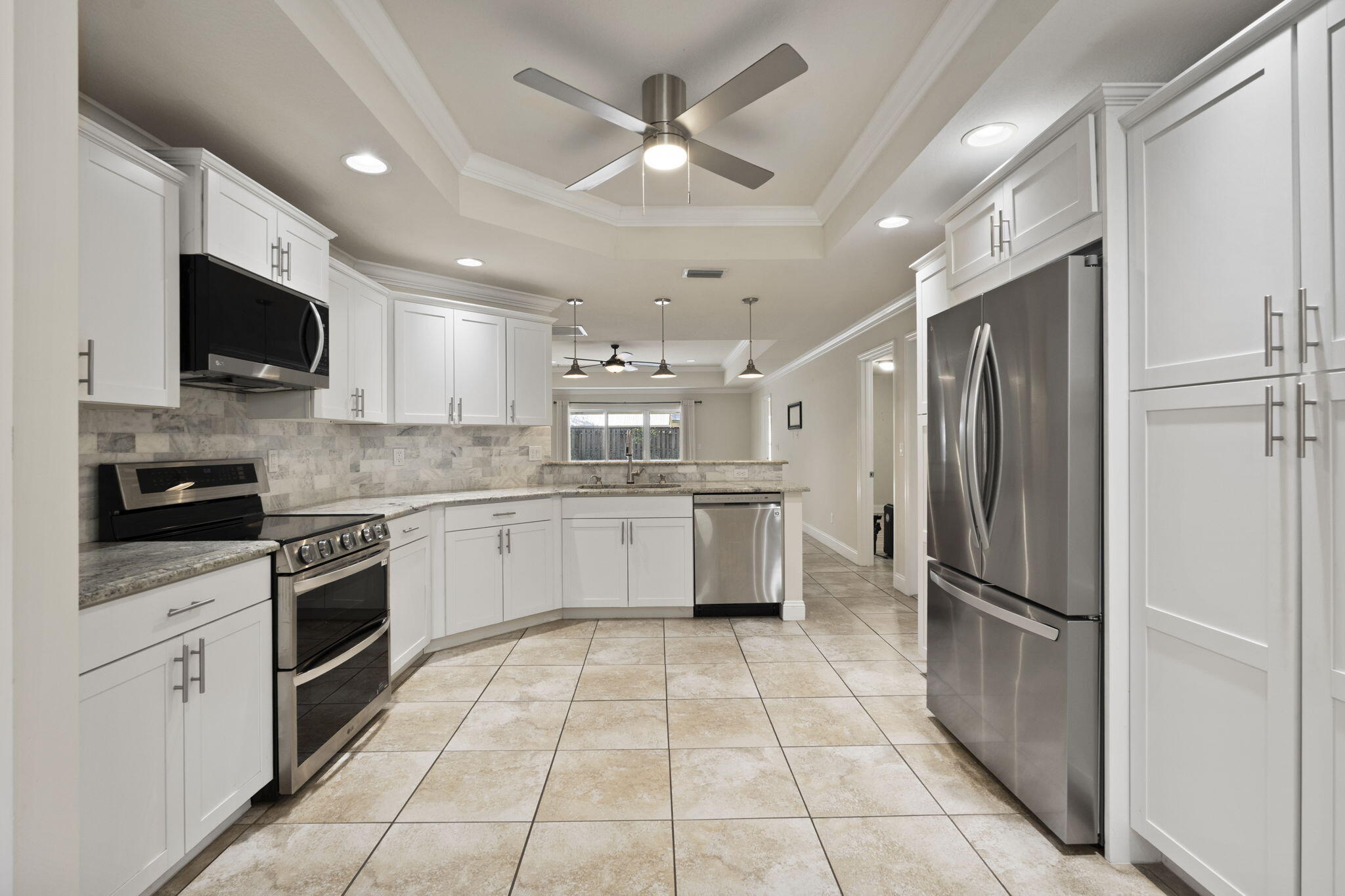 339 Southwest Winnachee Drive Stuart, FL 34994 - Photo 11 of 52 a kitchen with a refrigerator a sink and cabinets