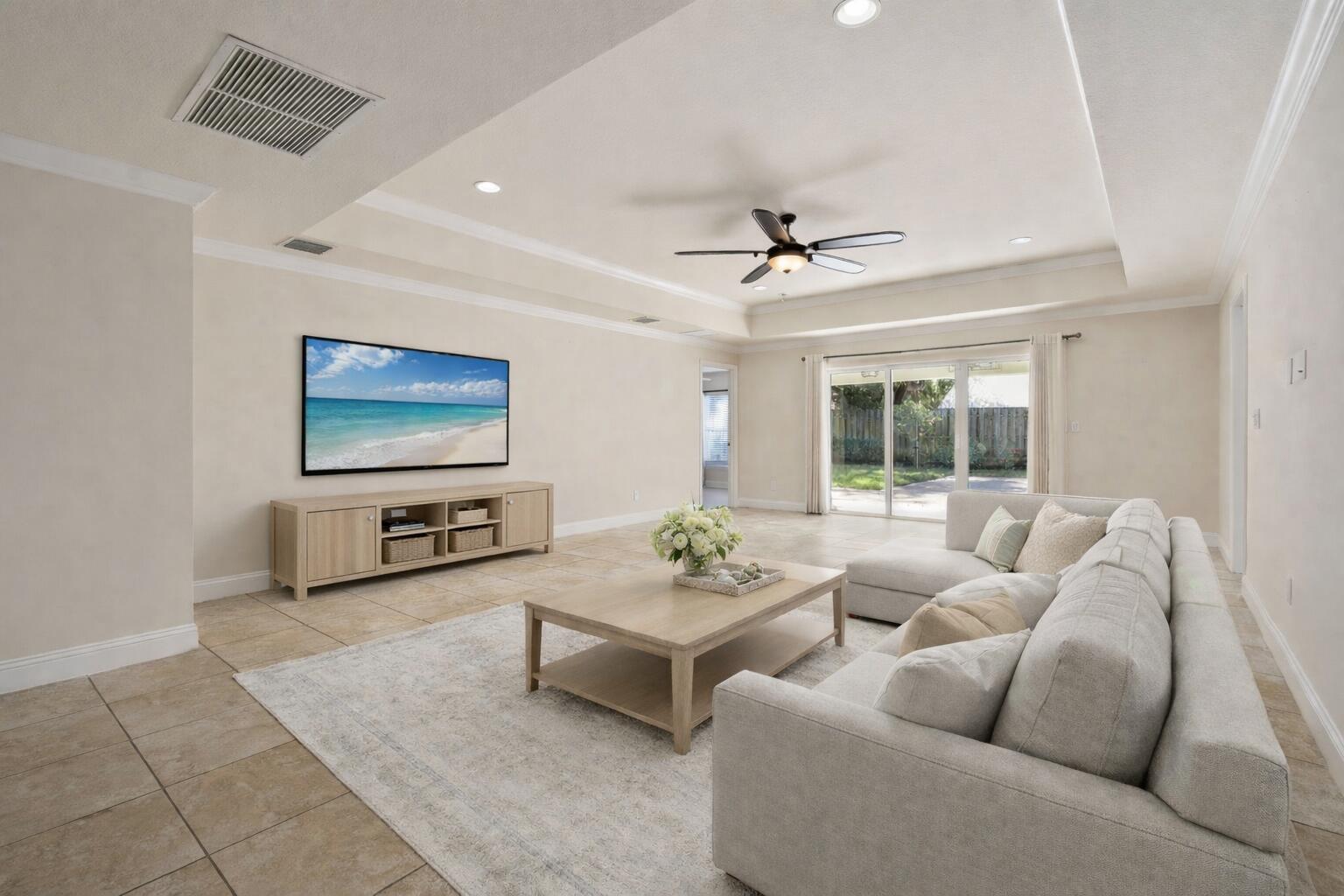 339 Southwest Winnachee Drive Stuart, FL 34994 - Photo 15 of 52 a living room with furniture a large window and a flat screen tv