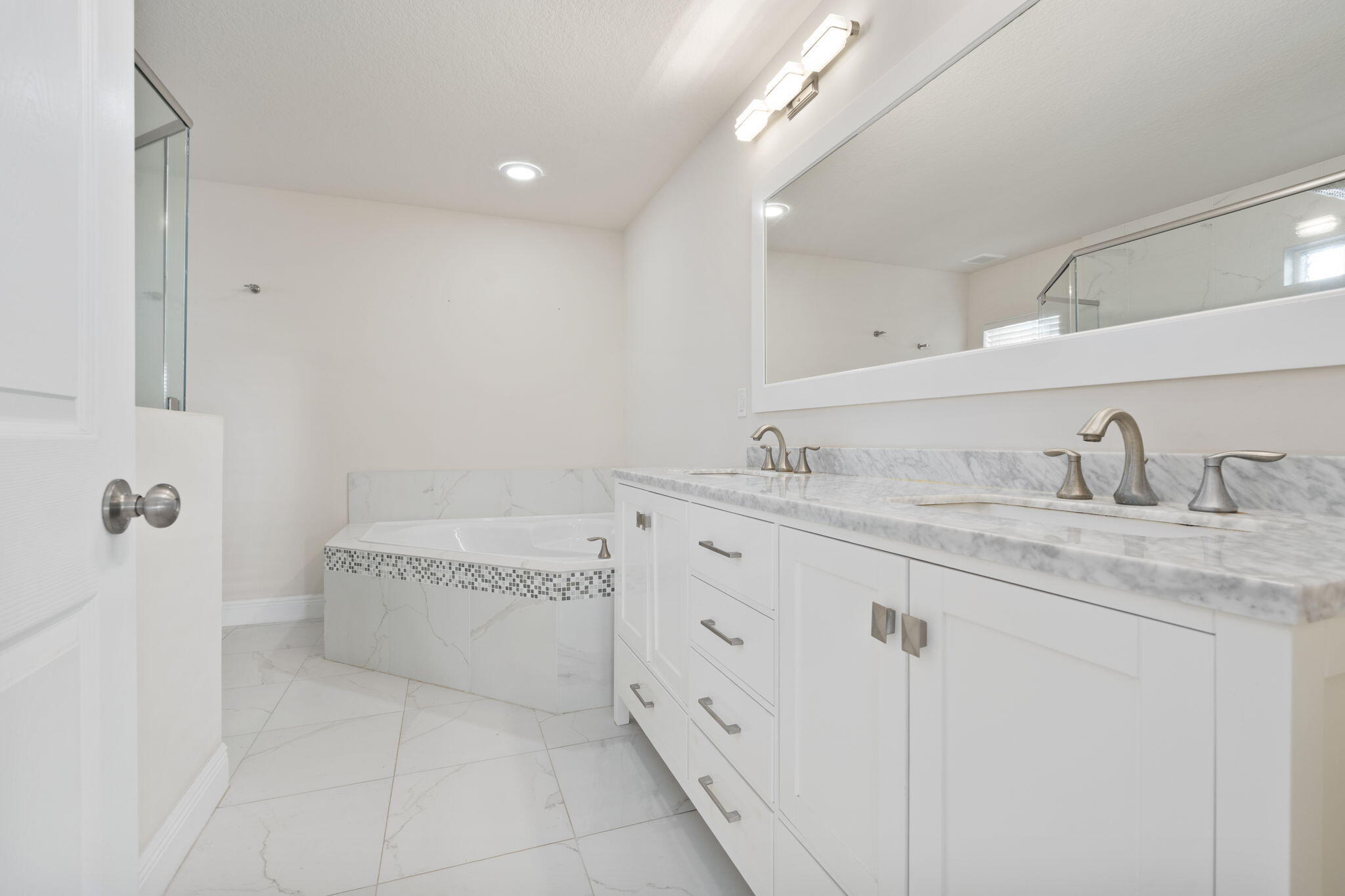 339 Southwest Winnachee Drive Stuart, FL 34994 - Photo 21 of 52 a bathroom with a granite countertop sink a mirror and bathtub