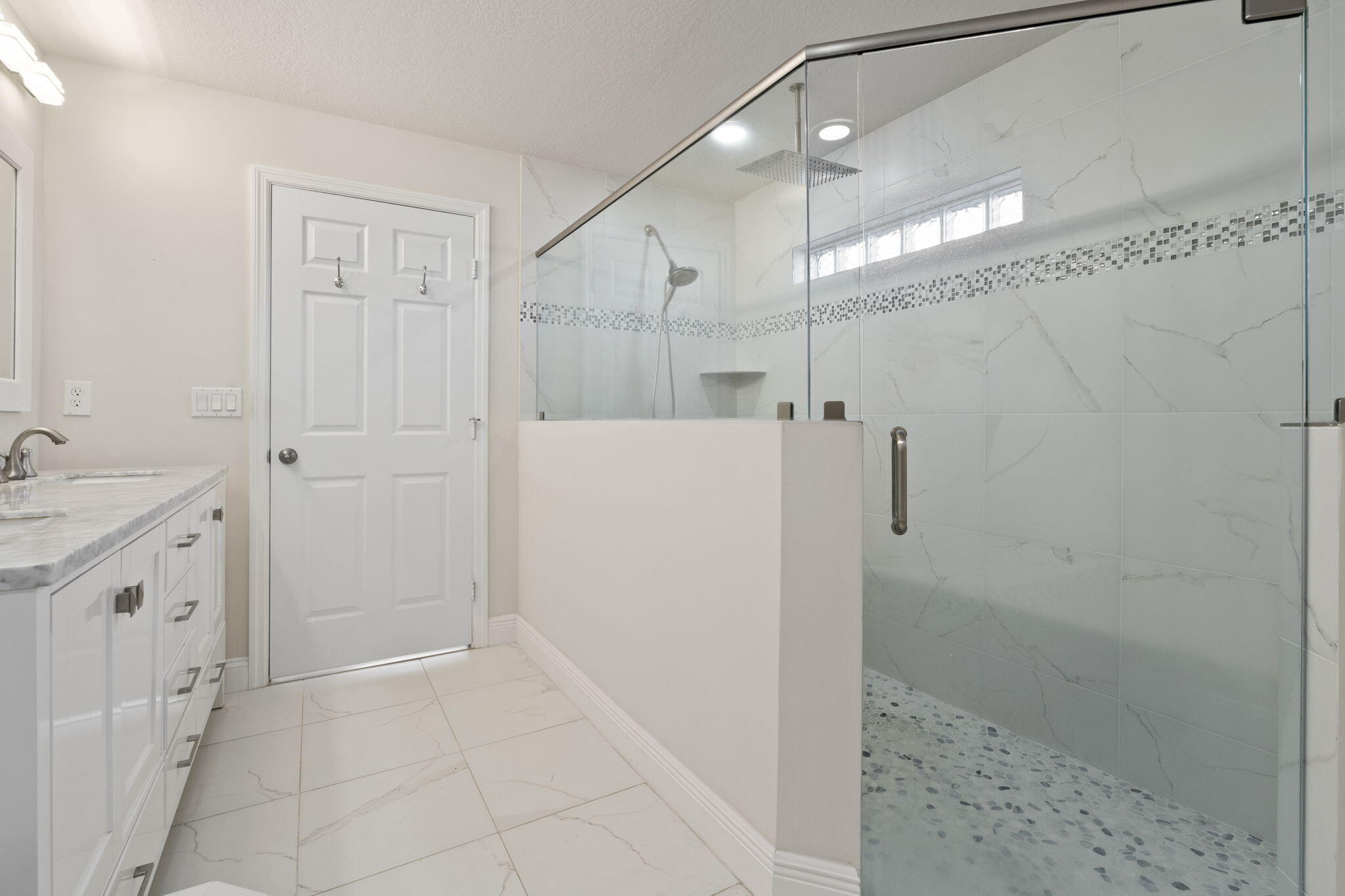339 Southwest Winnachee Drive Stuart, FL 34994 - Photo 22 of 52 a bathroom with a double vanity sink a toilet and shower