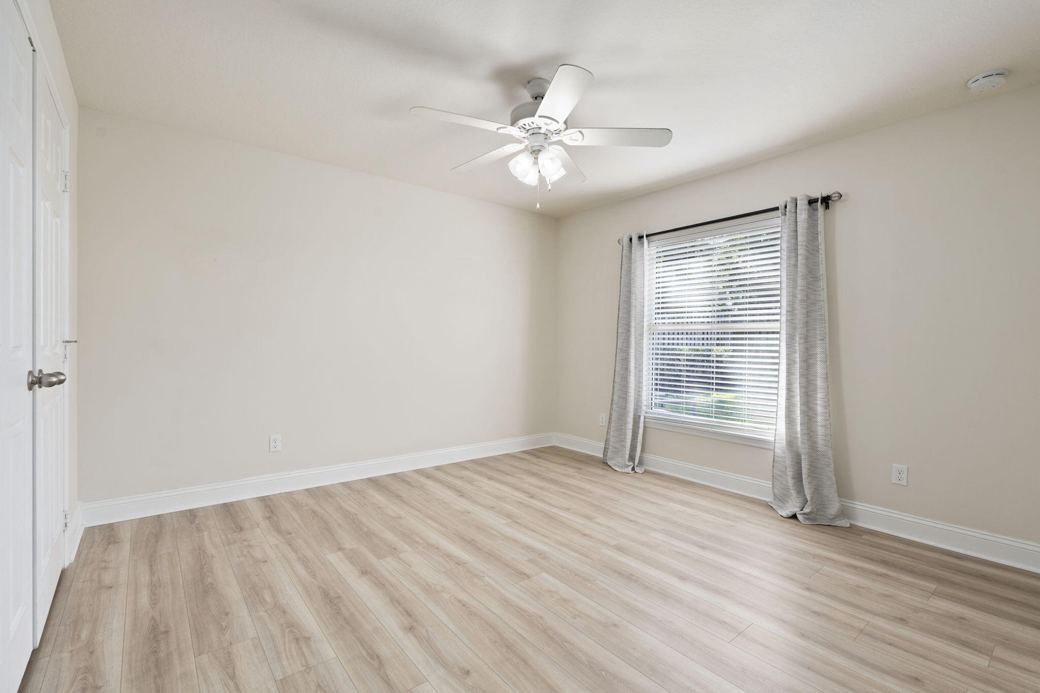 339 Southwest Winnachee Drive Stuart, FL 34994 - Photo 31 of 52 a view of an empty room with wooden floor and a window