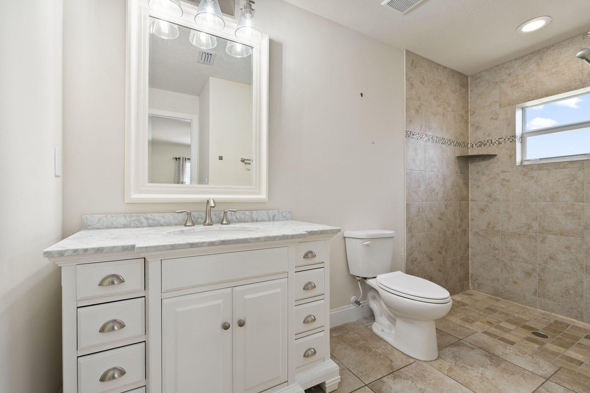 339 Southwest Winnachee Drive Stuart, FL 34994 - Photo 34 of 52 a bathroom with a granite countertop sink toilet and mirror