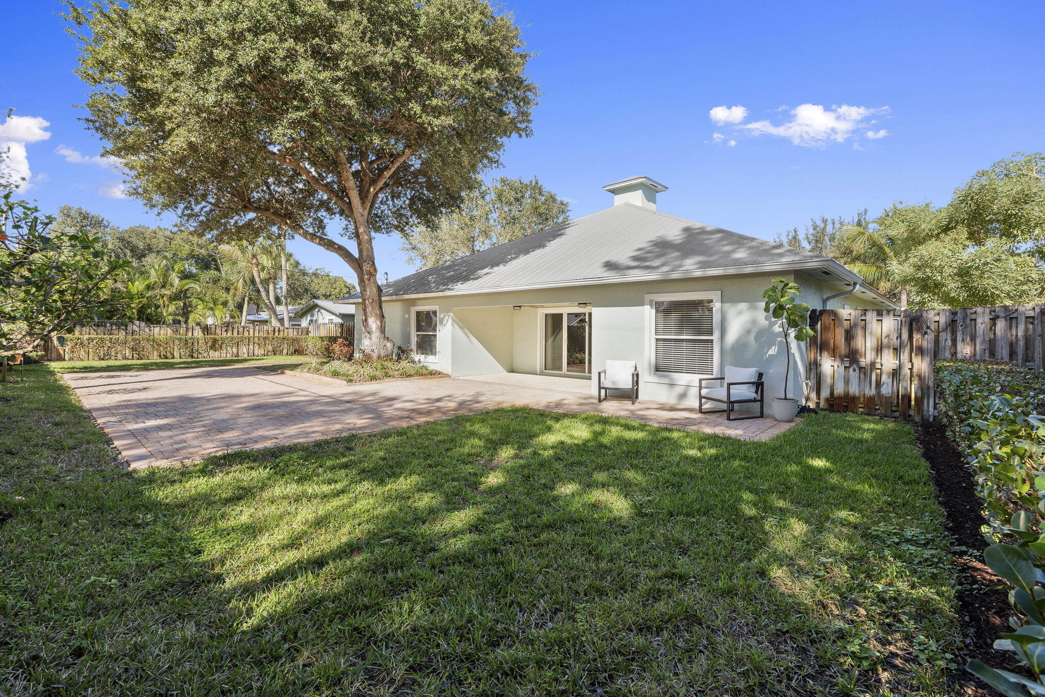 339 Southwest Winnachee Drive Stuart, FL 34994 - Photo 38 of 52 a front view of a house with yard porch and green space