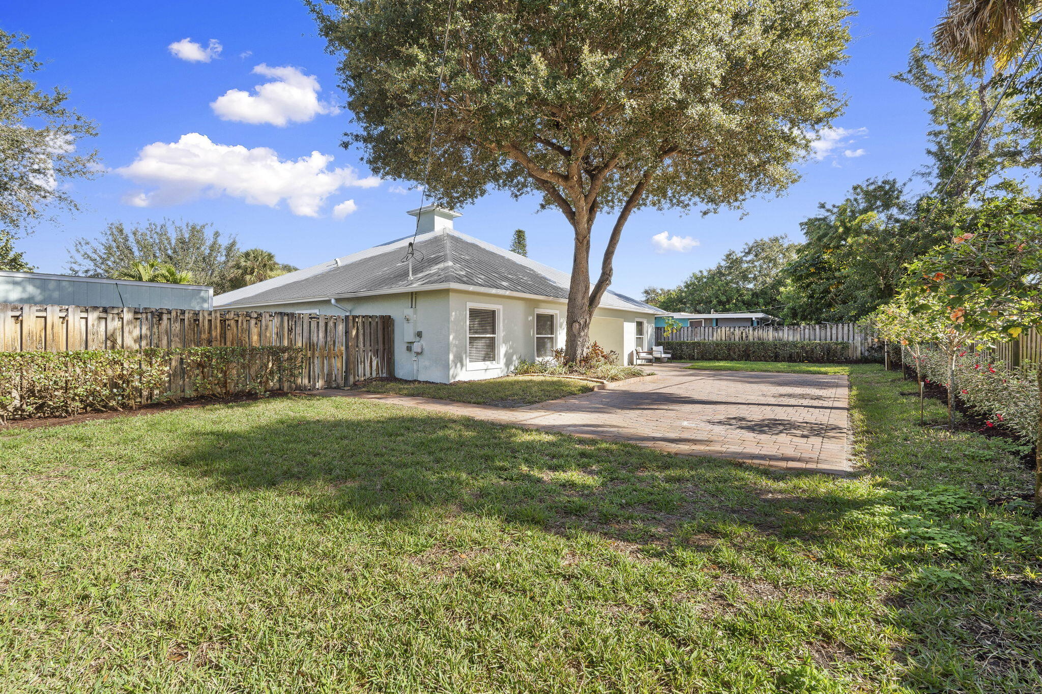 339 Southwest Winnachee Drive Stuart, FL 34994 - Photo 41 of 52 a front view of a house with garden