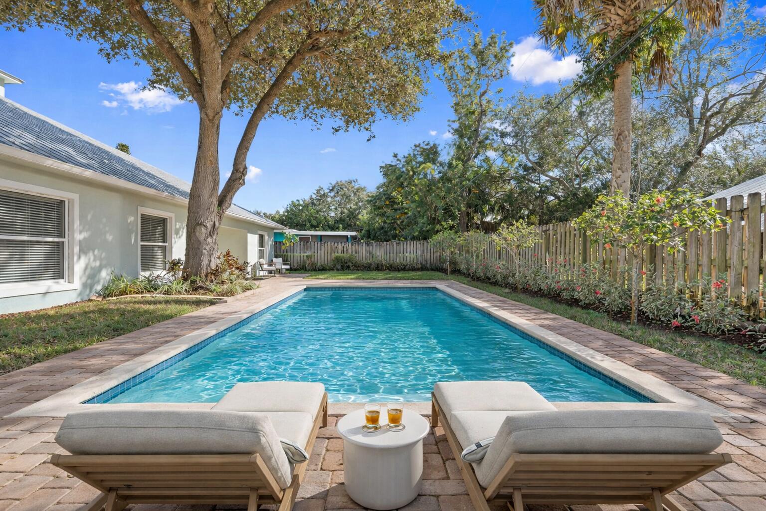 339 Southwest Winnachee Drive Stuart, FL 34994 - Photo 43 of 52 a view of a patio with chairs and a table