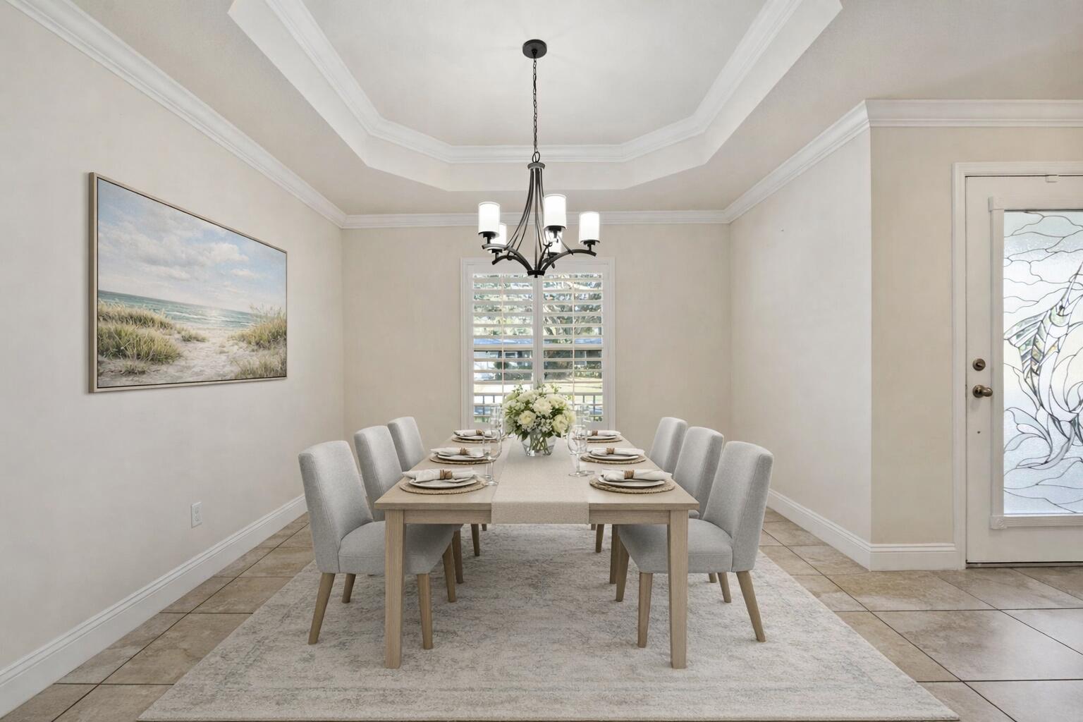 339 Southwest Winnachee Drive Stuart, FL 34994 - Photo 9 of 52 a dining room with furniture a rug and a chandelier