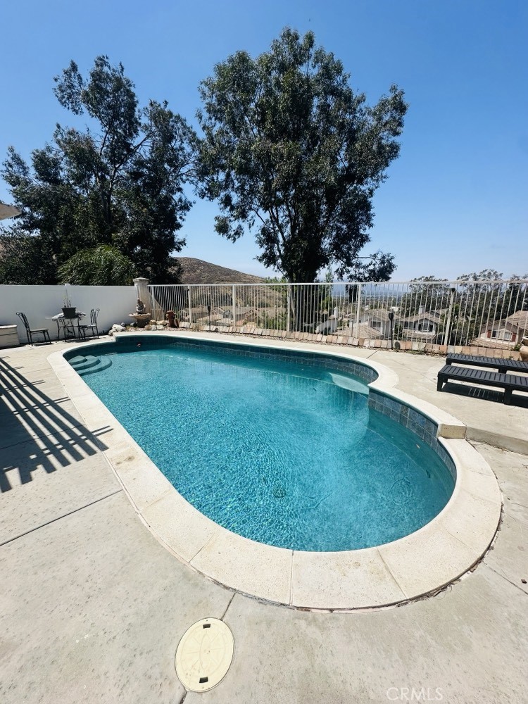 12031 East Sun Canyon Street Riverside, CA 92503 - Photo 3 of 3 a view of a swimming pool with a yard