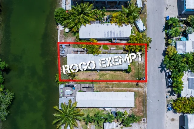 a sign that is sitting in front of flowers