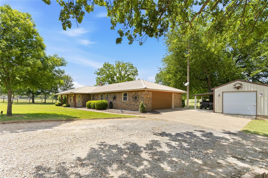 235 Magnus Road Denison, TX 75021 - Photo 26 of 35 a front view of a house with a yard and garage