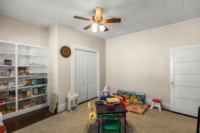 a room with furniture a rug toys and a window