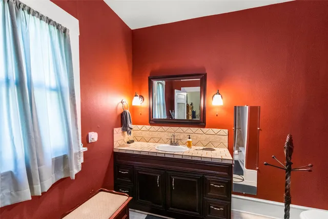 a bathroom with a sink and a mirror
