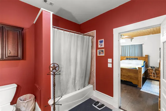 a bathroom with a sink a toilet a mirror and shower