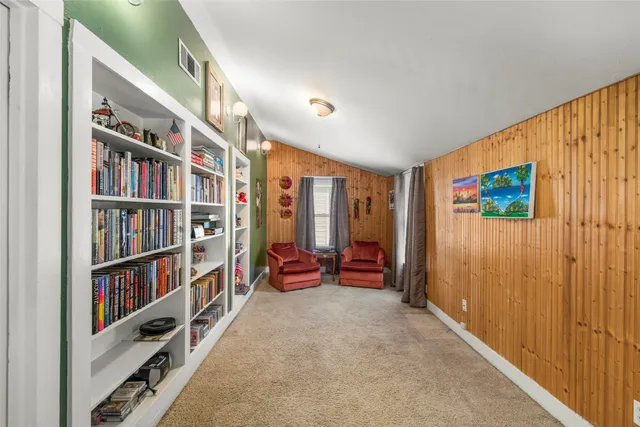 a living room with lots of books