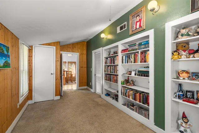 a view of room with shelves and book shelf