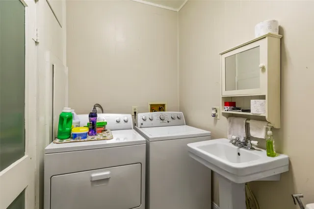a bathroom with a sink and a washer dryer