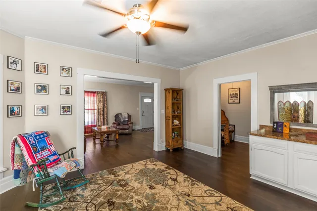a living room with furniture and wooden floor