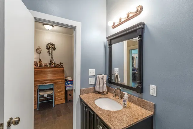 a bathroom with a sink vanity and mirror