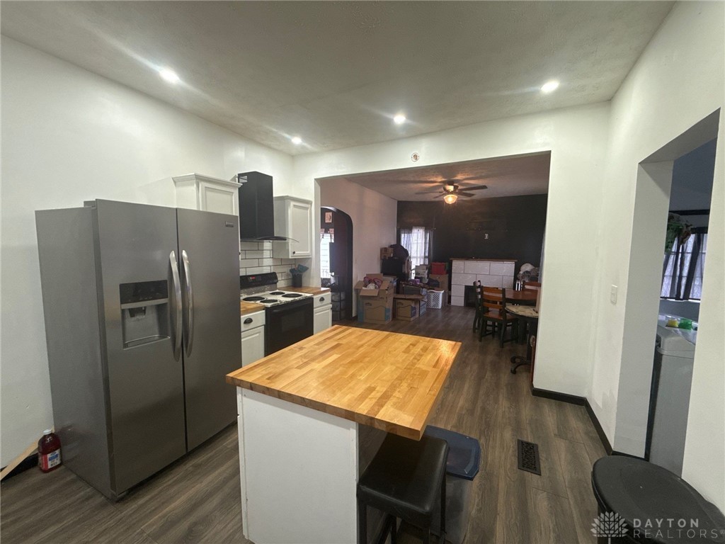 1125 West High Street Springfield, OH 45506 - Photo 13 of 39 This spacious kitchen, featuring a practical island, flows effortlessly into the inviting living area.