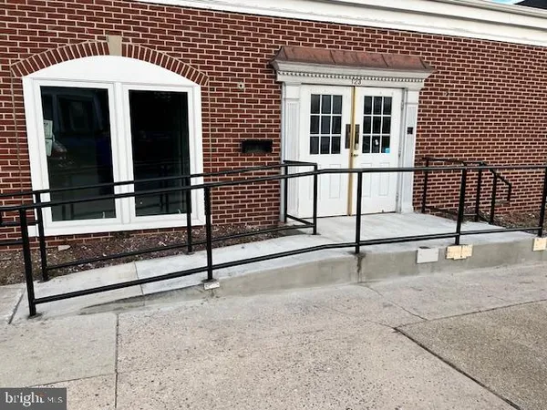 a view of a house with wooden fence