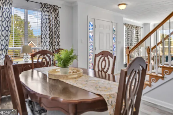 a view of a dining room with furniture and window