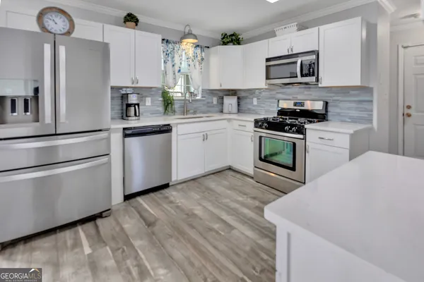 a kitchen with a refrigerator stove and a sink