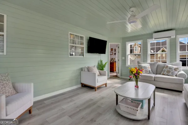 a living room with furniture and a flat screen tv