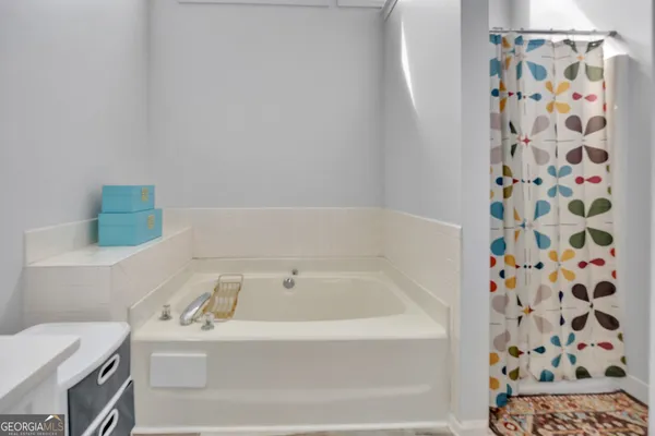 a bathroom with a bathtub and shower