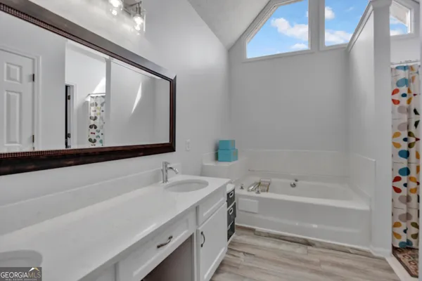 a bathroom with a bathtub and a sink