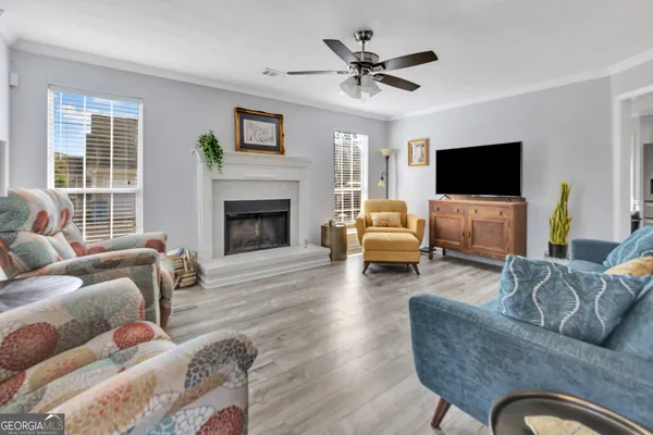 a living room with furniture a flat screen tv and a fireplace