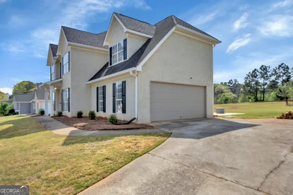 a view of a house with entertaining space and a tree