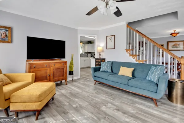 a living room with furniture and a flat screen tv