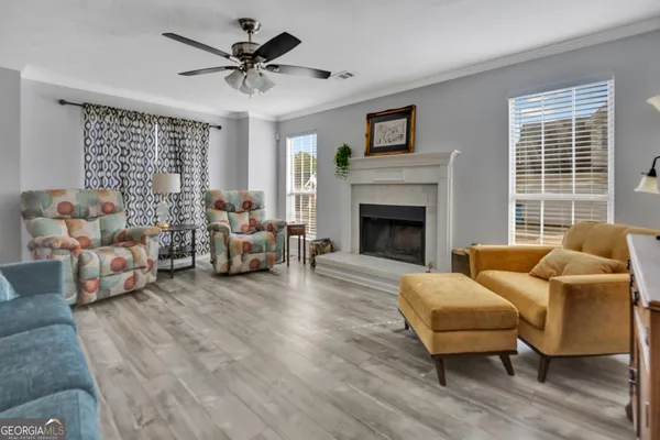 a living room with furniture and a fireplace