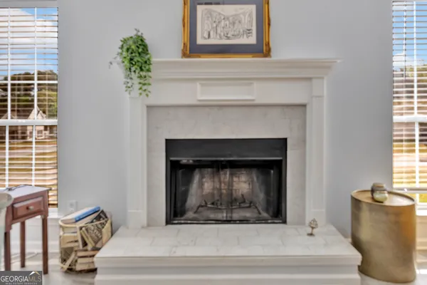 a living room with a fireplace and windows