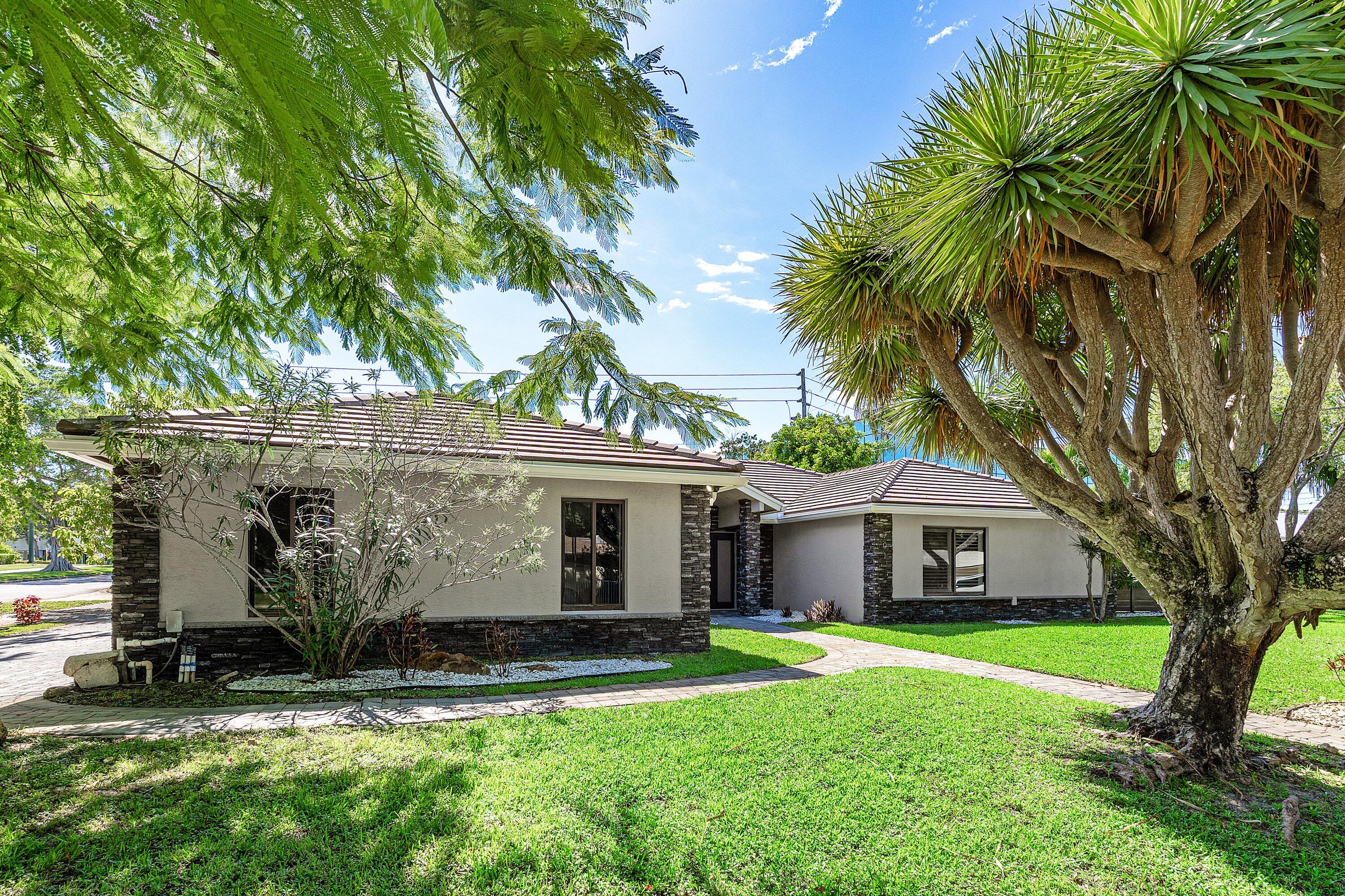 a front view of house with yard and green space