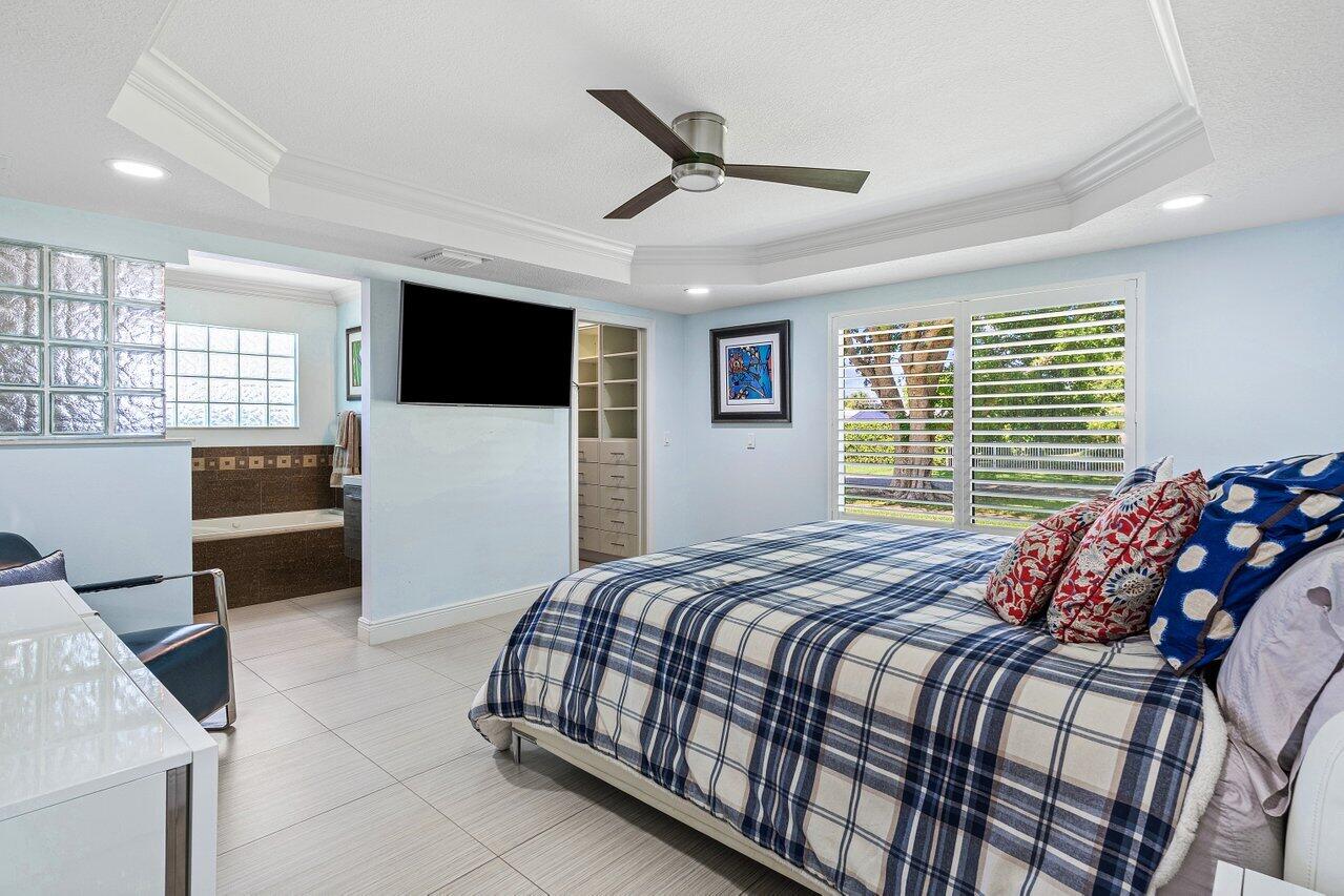 701 Buoy Road North Palm Beach, FL 33408 - Photo 20 of 52 a bedroom with a bed and a television