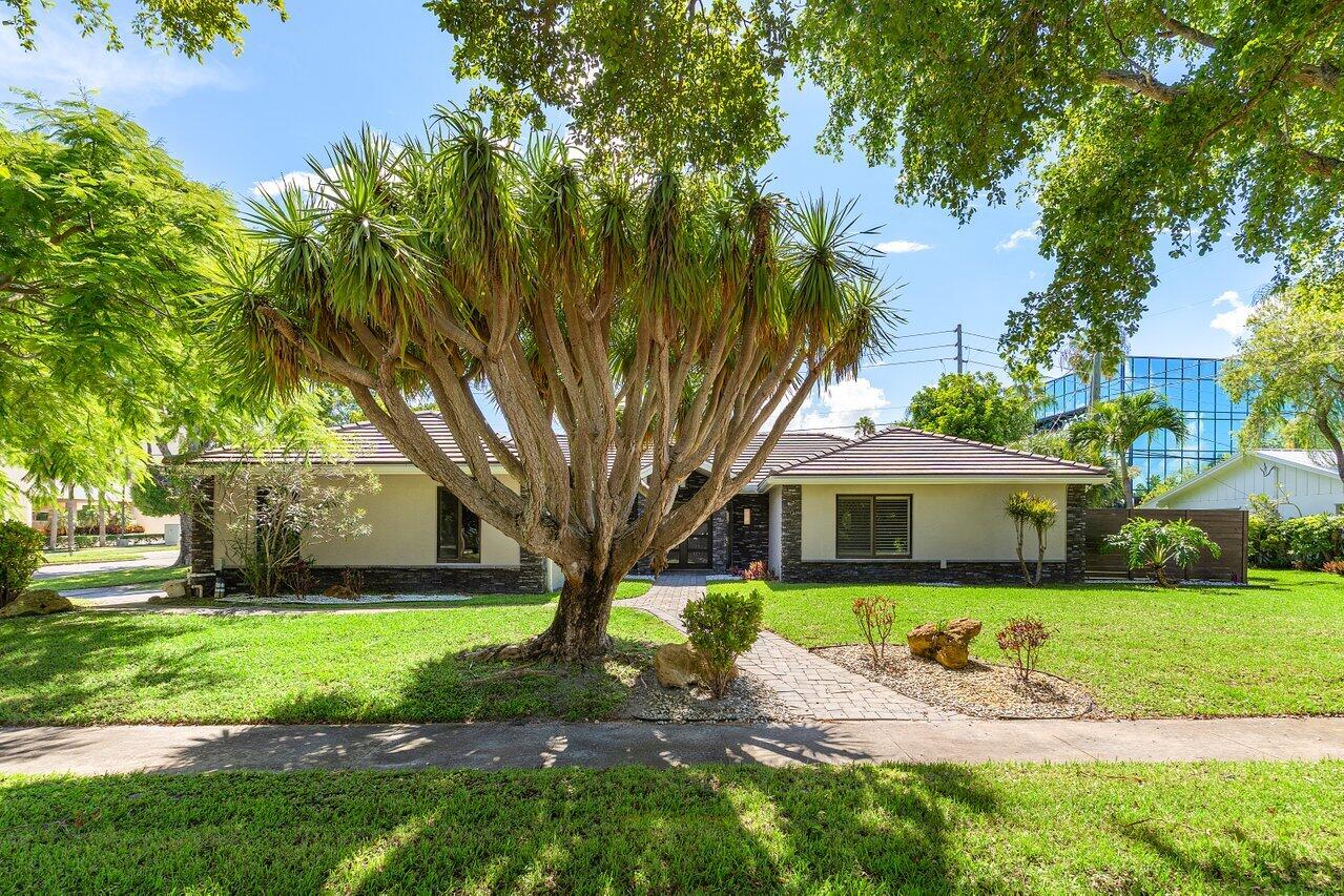701 Buoy Road North Palm Beach, FL 33408 - Photo 2 of 52 a front view of a house with a garden and tree
