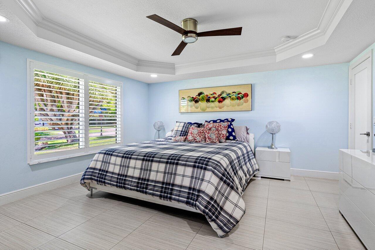 701 Buoy Road North Palm Beach, FL 33408 - Photo 21 of 52 a bed sitting in a bedroom next to a window