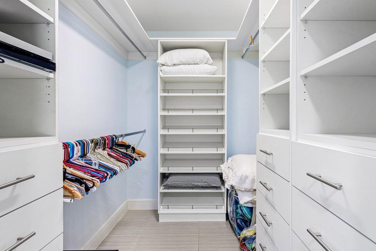 701 Buoy Road North Palm Beach, FL 33408 - Photo 22 of 52 a view of walk in closet with clothes and shoes